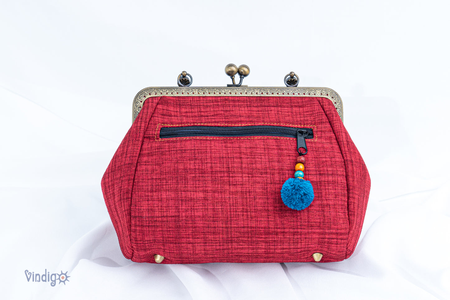 Red bag with vintage tribal embroidery and straight copper-binding