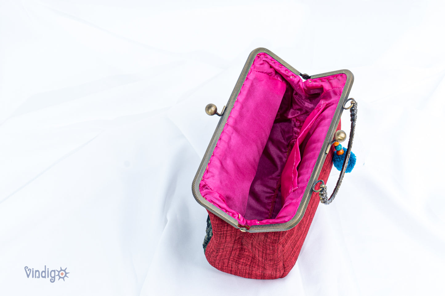 Red bag with vintage tribal embroidery and straight copper-binding