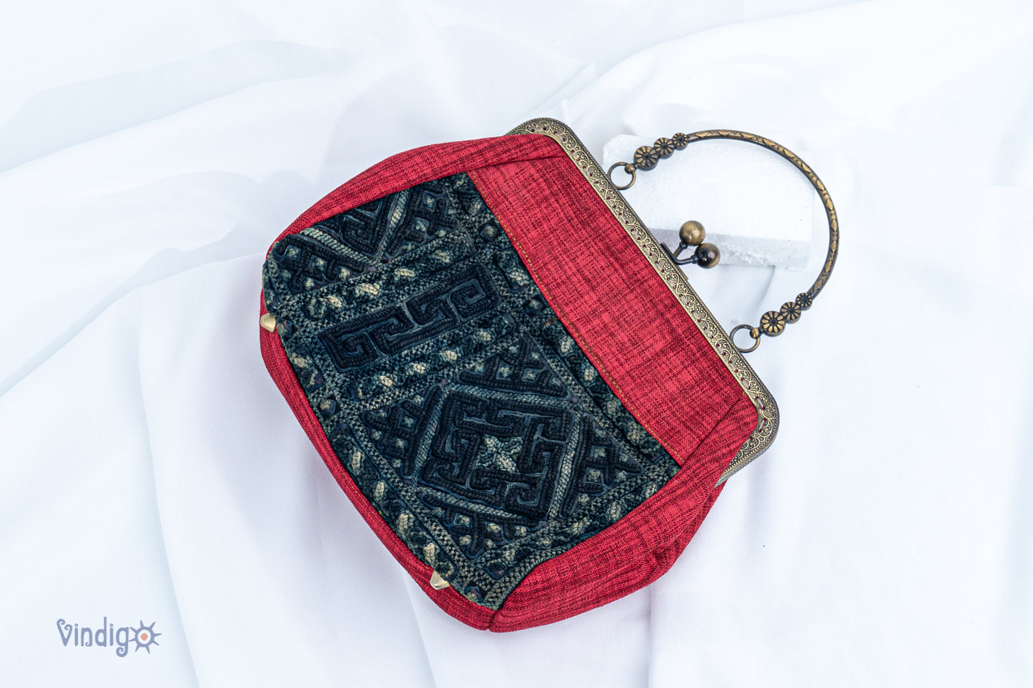 Red bag with vintage tribal embroidery and straight copper-binding