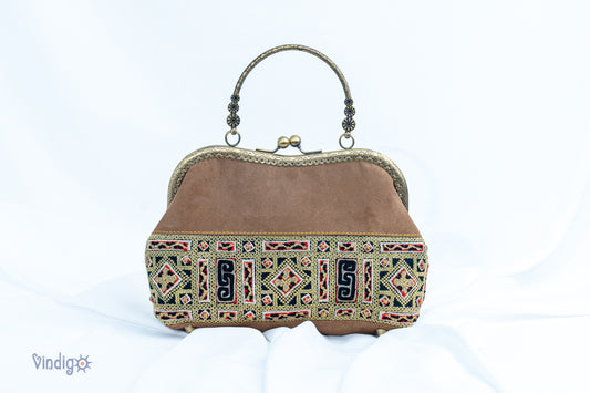 Faux leather bag with vintage tribal embroidery and copper-binding