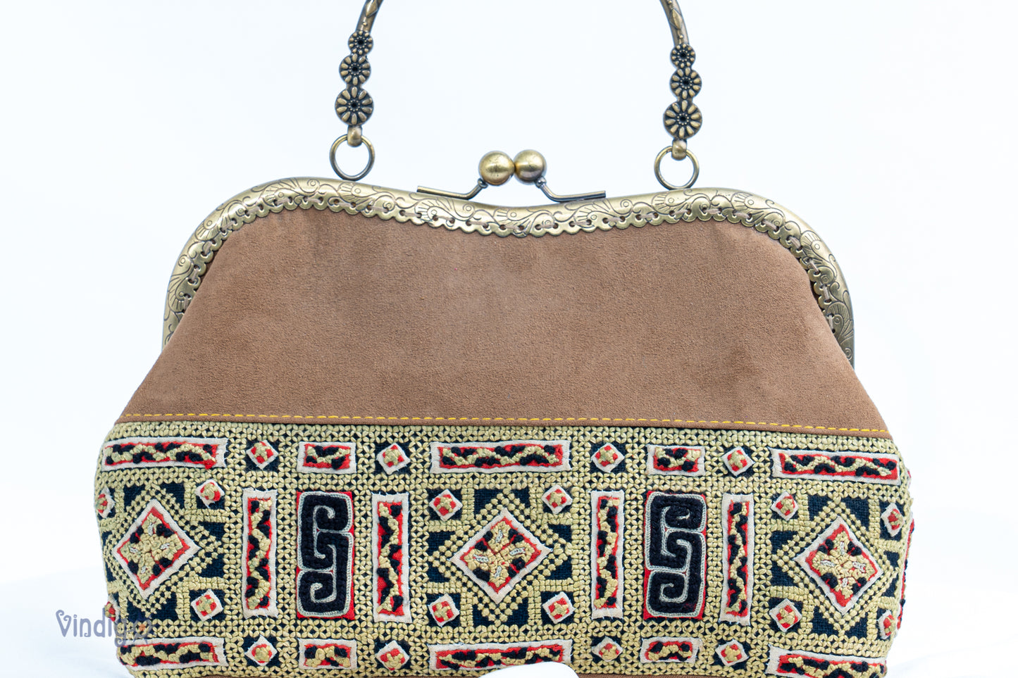 Faux leather bag with vintage tribal embroidery and copper-binding