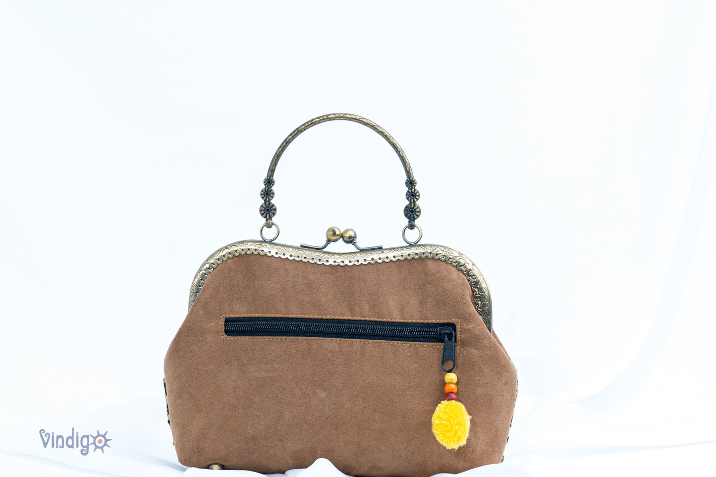 Faux leather bag with vintage tribal embroidery and copper-binding