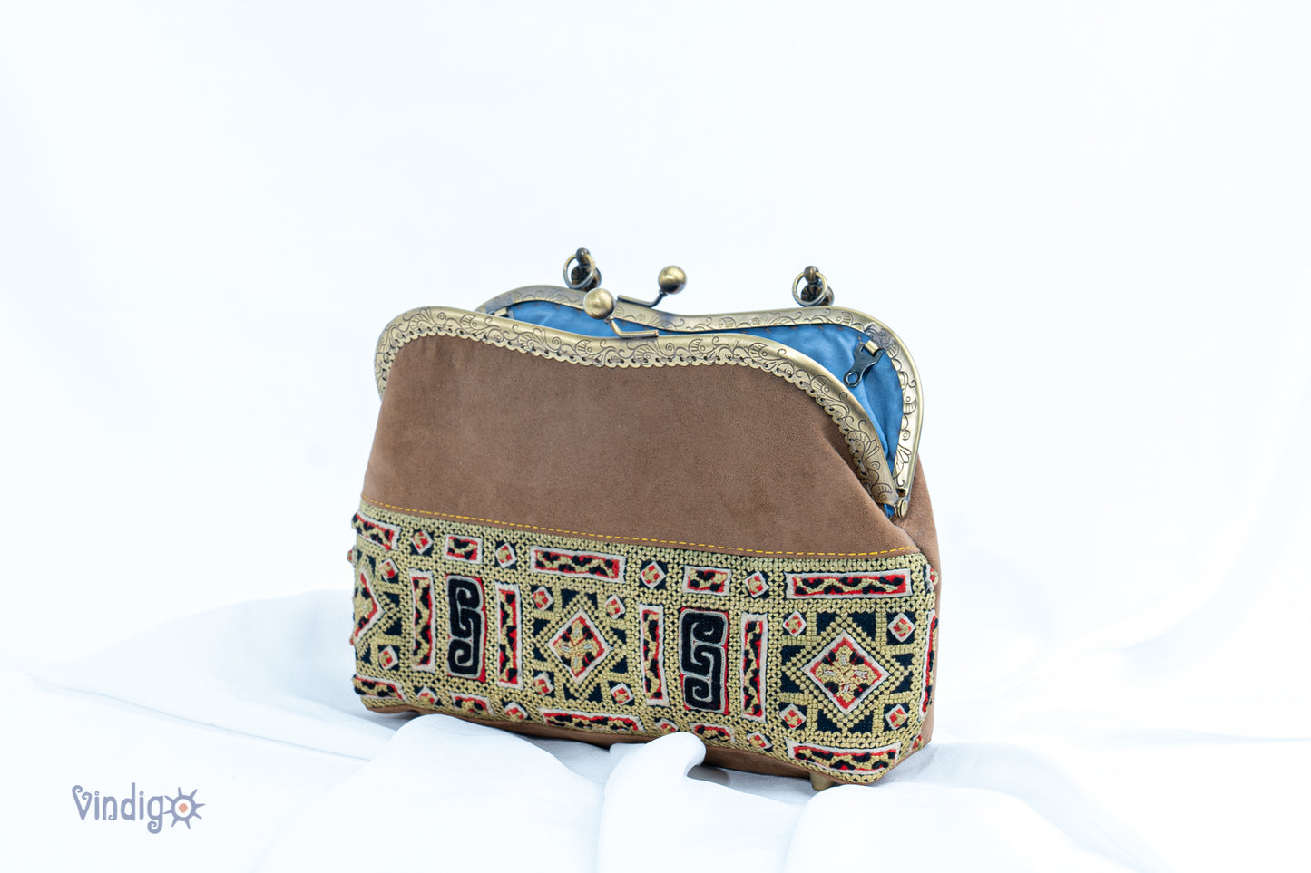 Faux leather bag with vintage tribal embroidery and copper-binding