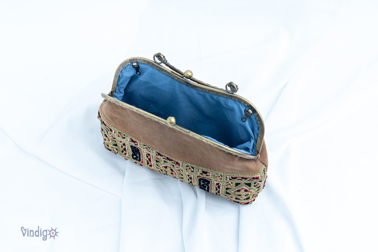 Faux leather bag with vintage tribal embroidery and copper-binding