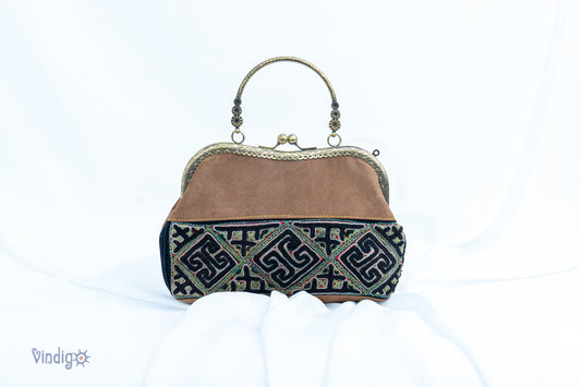 Brown faux leather bag with vintage tribal embroidery and copper-binding