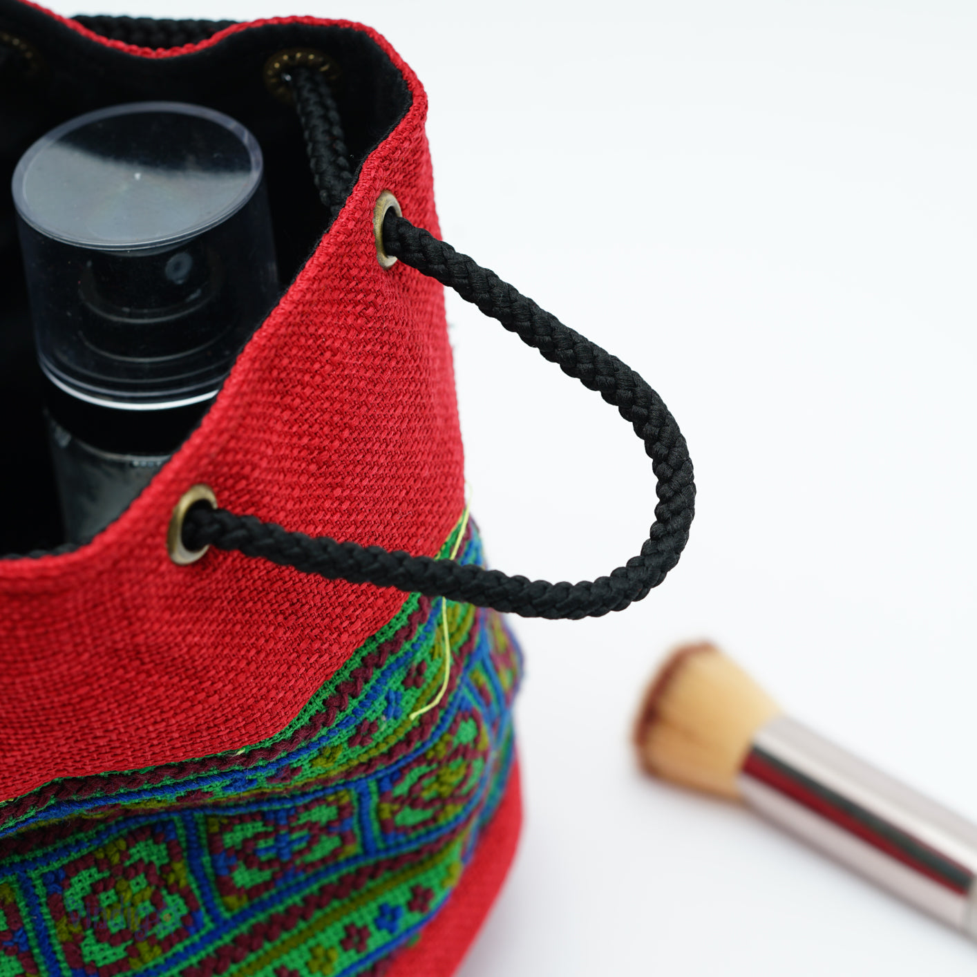 Red multi-purpose bag with string, Hemp, tribal pattern on green background