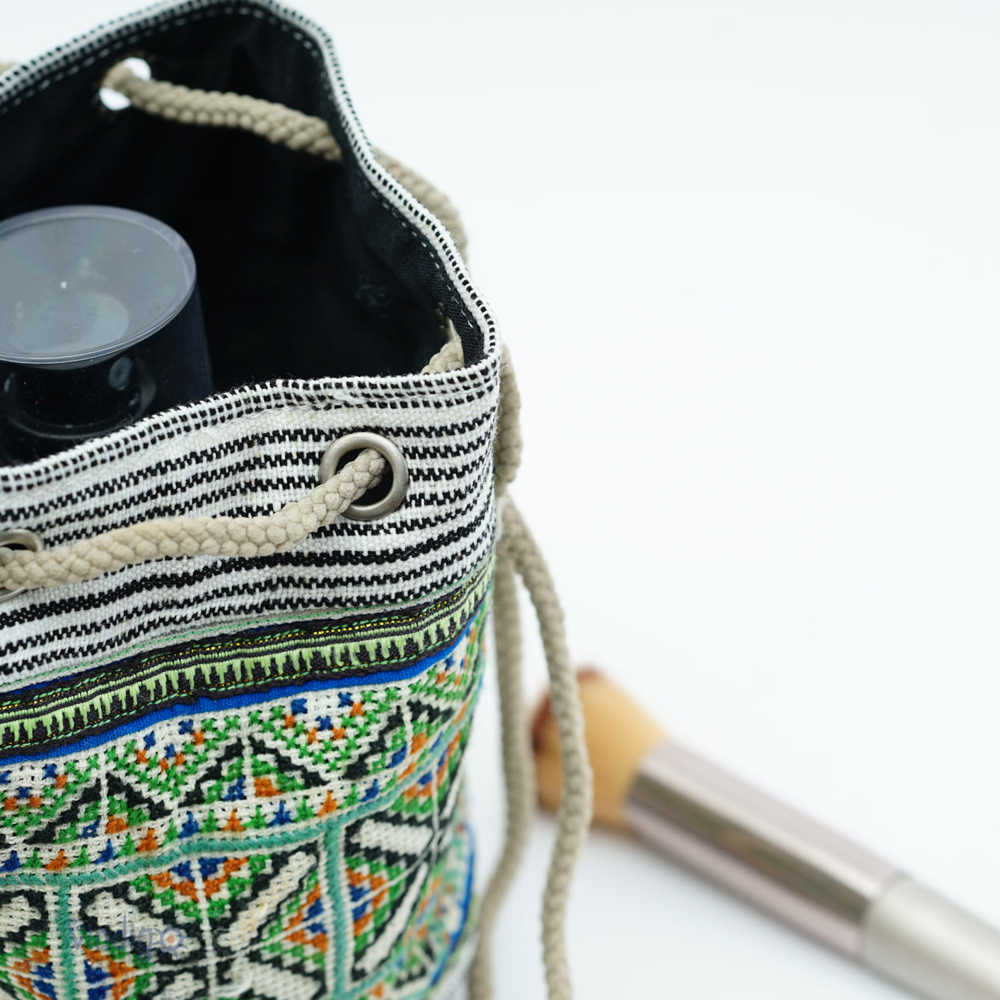 Beige mini hemp bag with string, black and white stripe with green tribal pattern